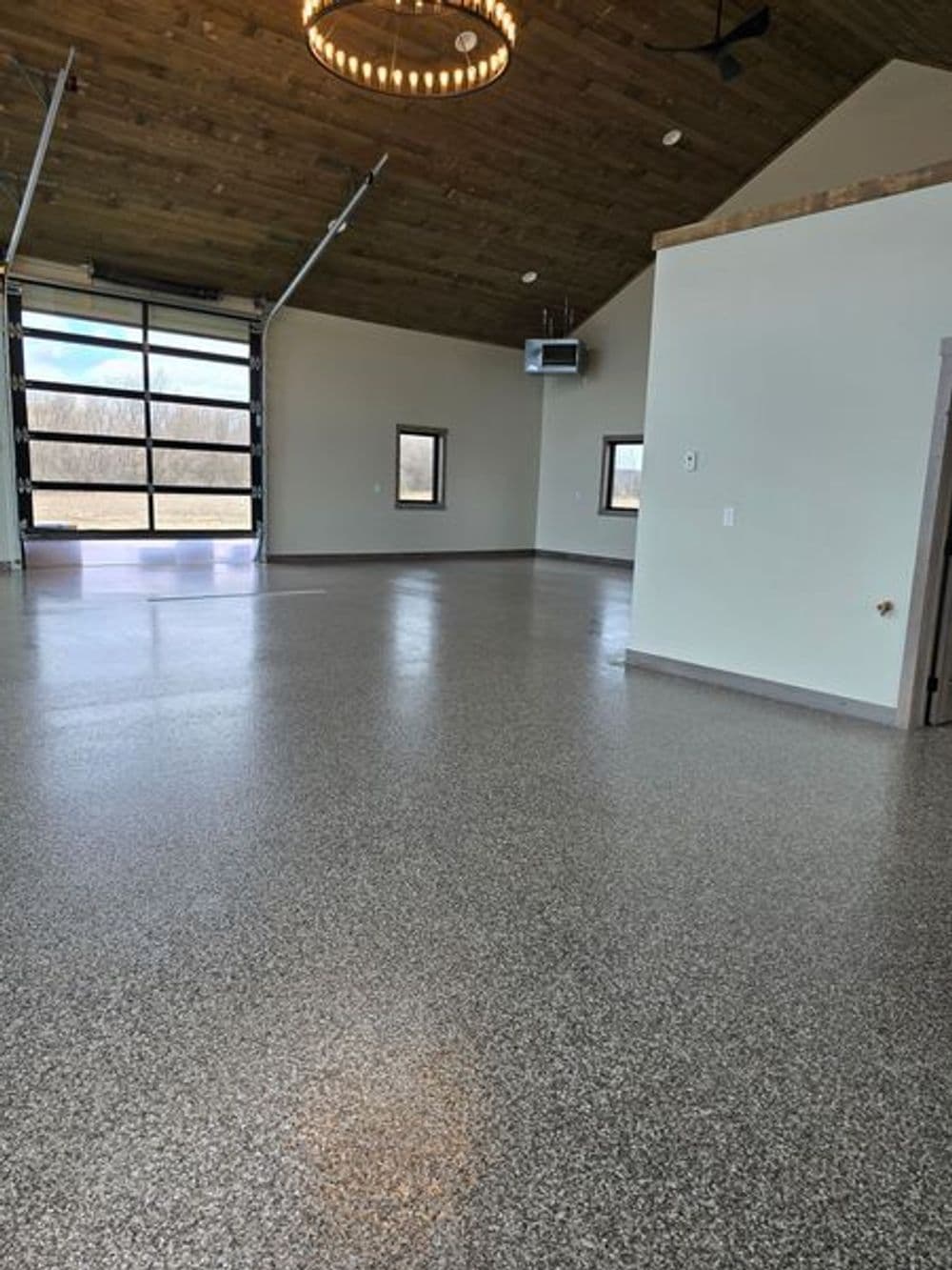 Spacious, modern interior with polished flooring and large windows in a bright room.