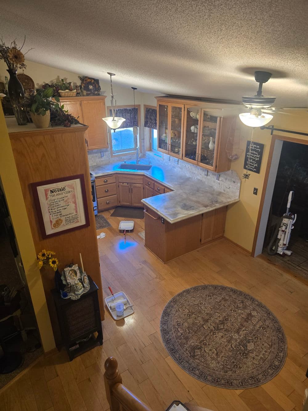Spacious kitchen with wooden cabinetry, countertop, and modern appliances, featuring a cozy rug.