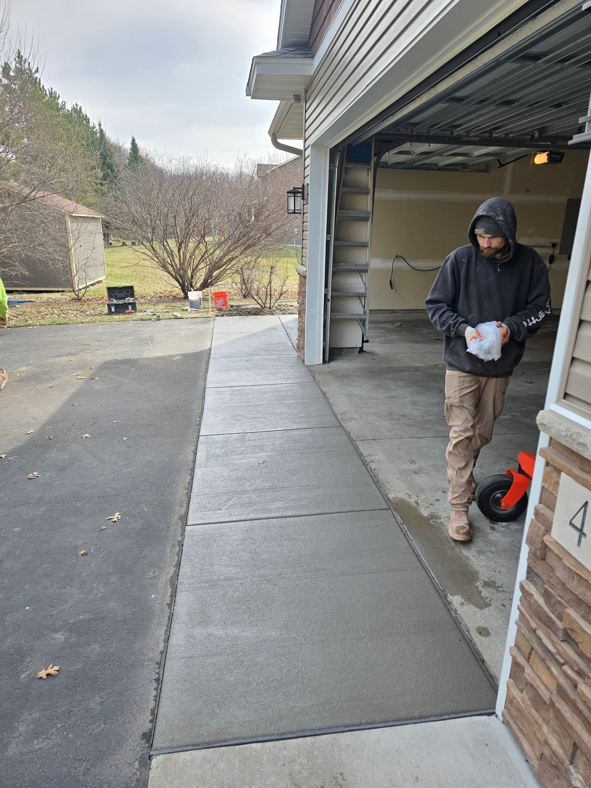 Fresh Concrete Apron Poured Over a Settling Asphalt Driveway image